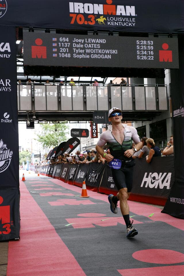 Joey crossing the IRONMAN Louisville finish line